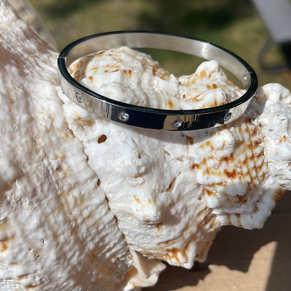 Silver tone bangle bracelet with faux diamonds
